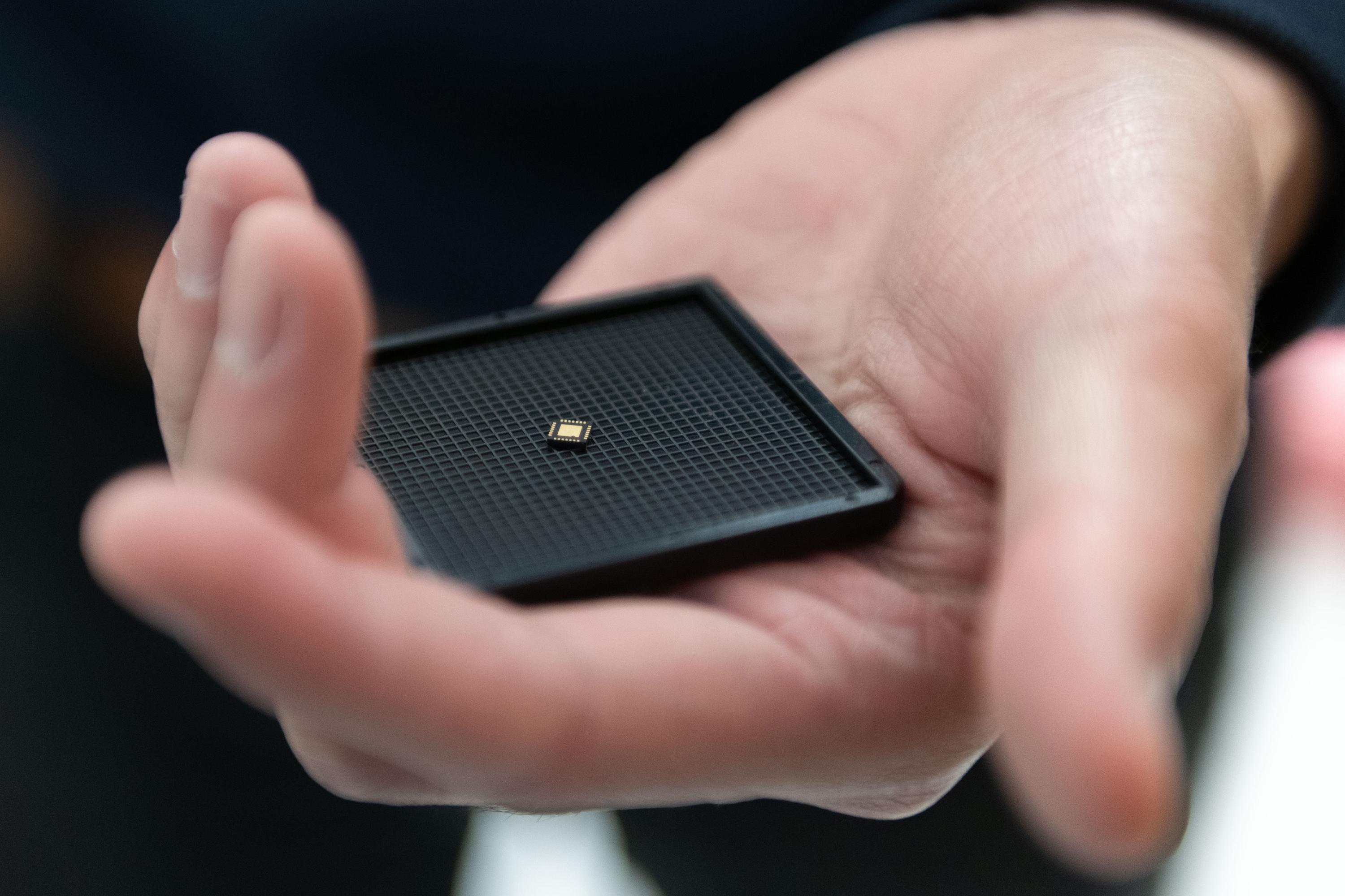 Georgia Tech researchers have developed an ultra-low power hybrid chip inspired by the brain that could help give palm-sized robots the ability to collaborate and learn from their experiences. (Photo: Allison Carter, Georgia Tech)