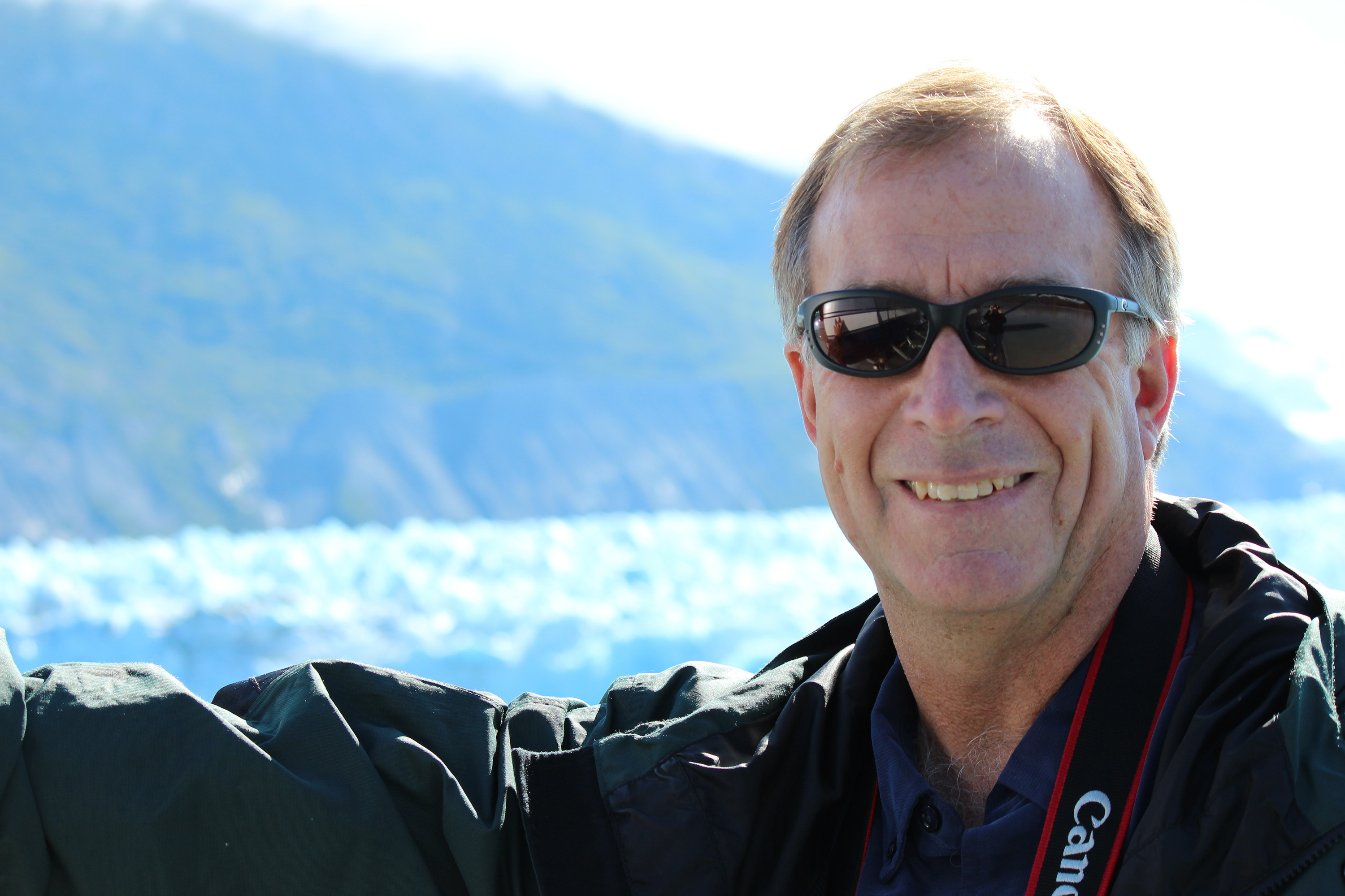 Georgia Tech Teasley Professor Mark Hay is shown with a background of glaciers in Alaska. Hay has spent his career understanding what's killing the world's coral reefs. (Credit: Candace Klein)