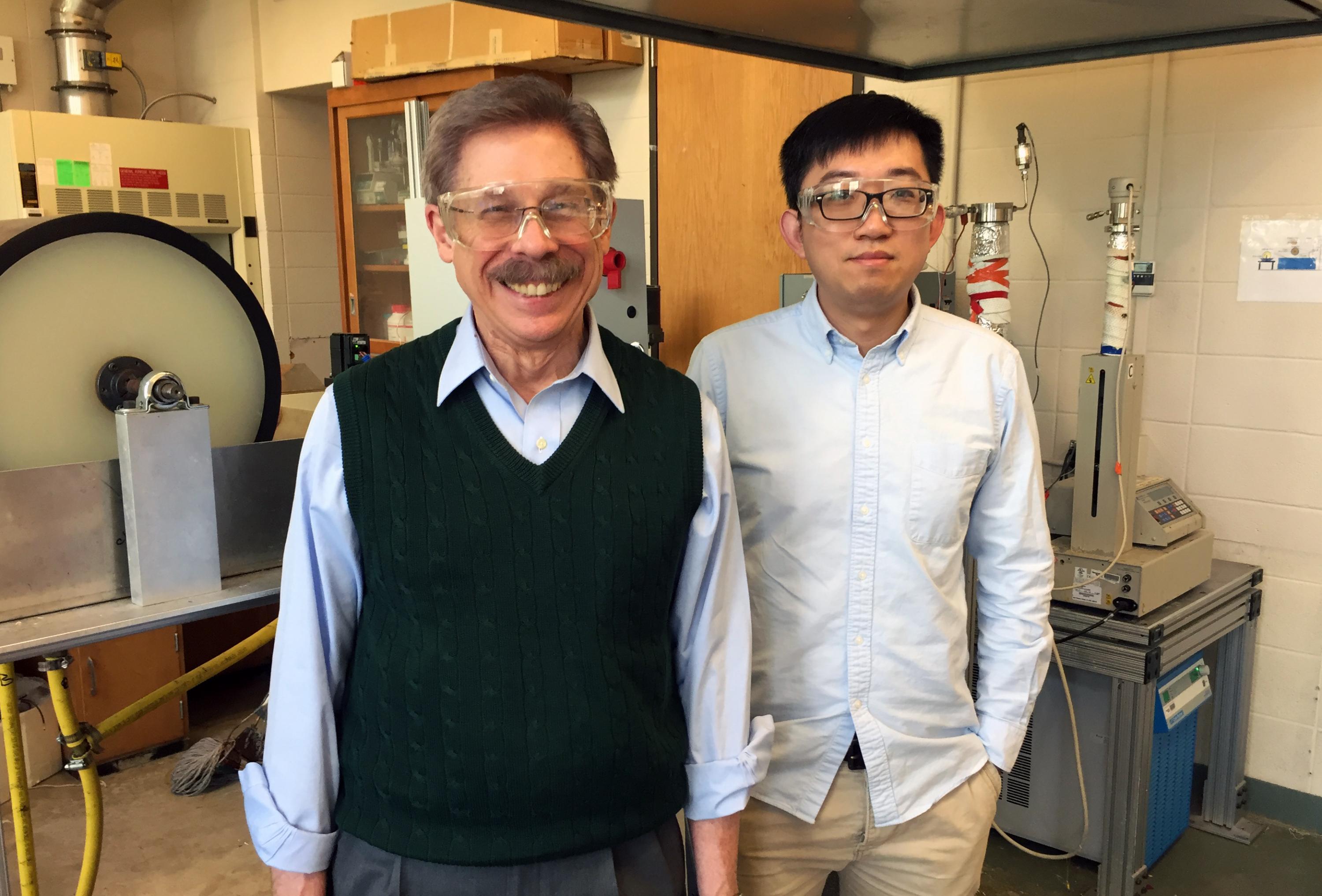Georgia Tech professor William J. Koros and research engineer Chen Zhang are shown with a dry-wet hollow fiber spinning system. (Credit: John Toon, Georgia Tech)