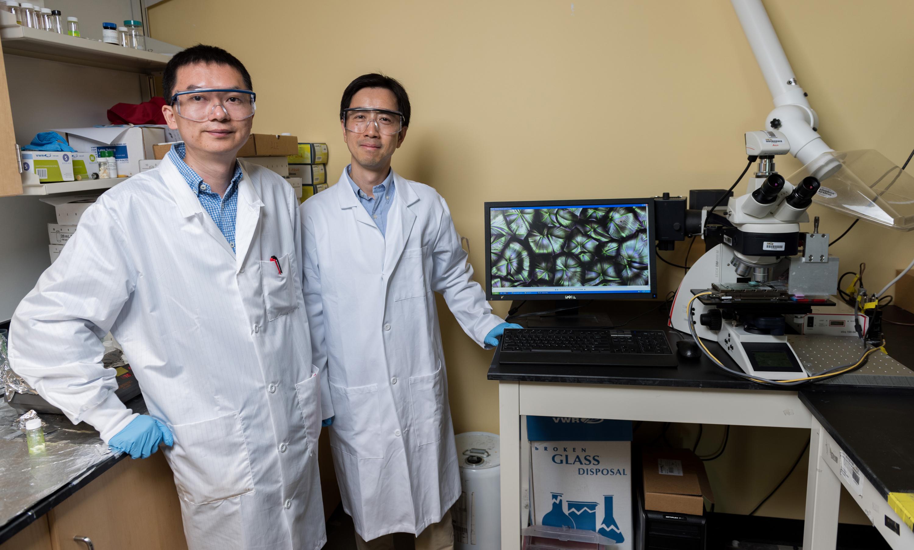 Research Scientist Ming He (left) and Professor Zhiqun Lin are shown in Lin’s laboratory in the School of Materials Science and Engineering at the Georgia Institute of Technology. (Credit: Rob Felt, Georgia Tech)