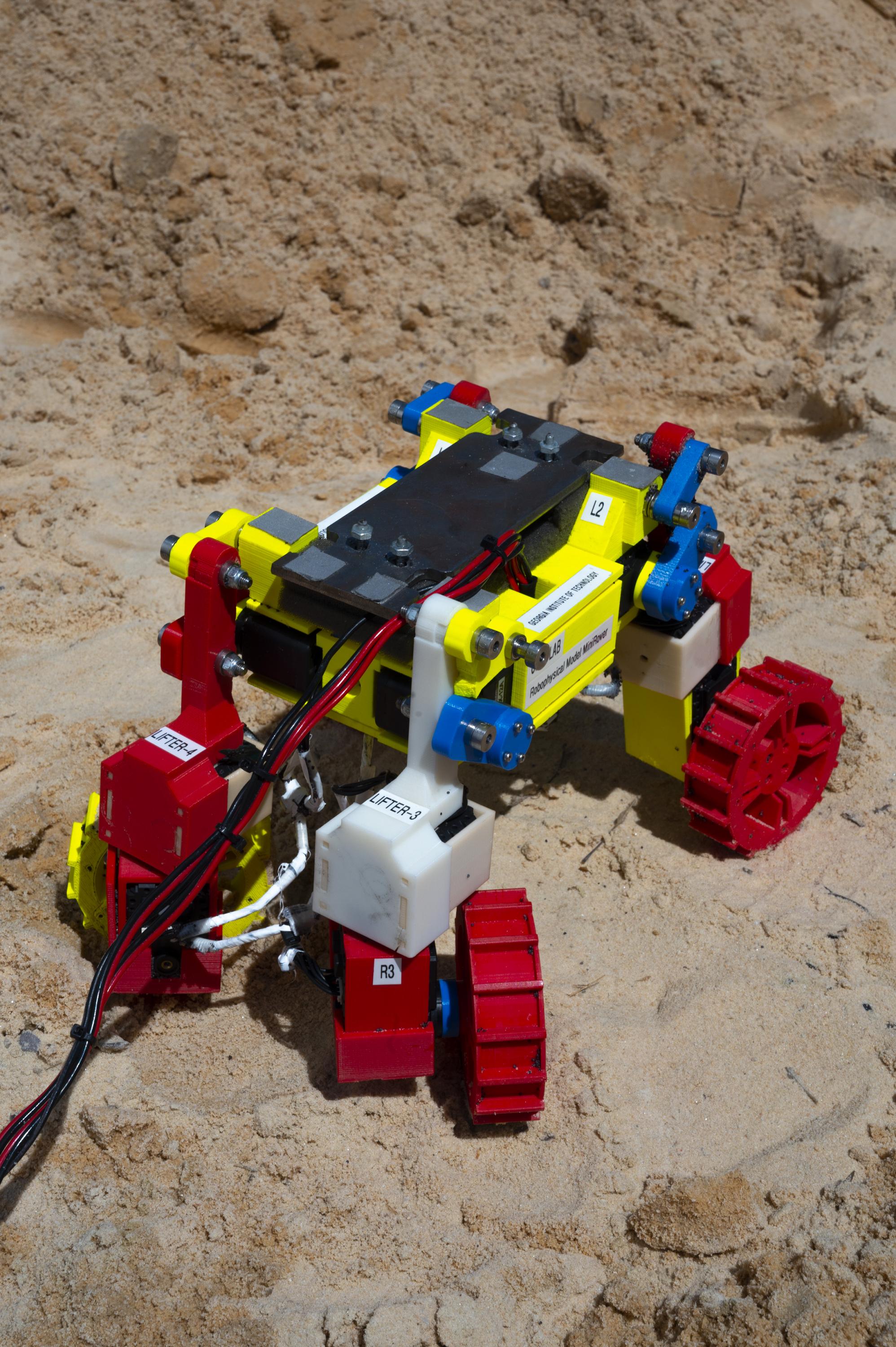 Built with multifunctional appendages able to spin wheels that can also be wiggled and lifted, the Mini Rover was modeled on a novel NASA rover design and used in the laboratory to develop and test complex locomotion techniques robust enough to help it climb hills composed of granular material, here ordinary beach sand. (Credit: Christopher Moore, Georgia Tech)