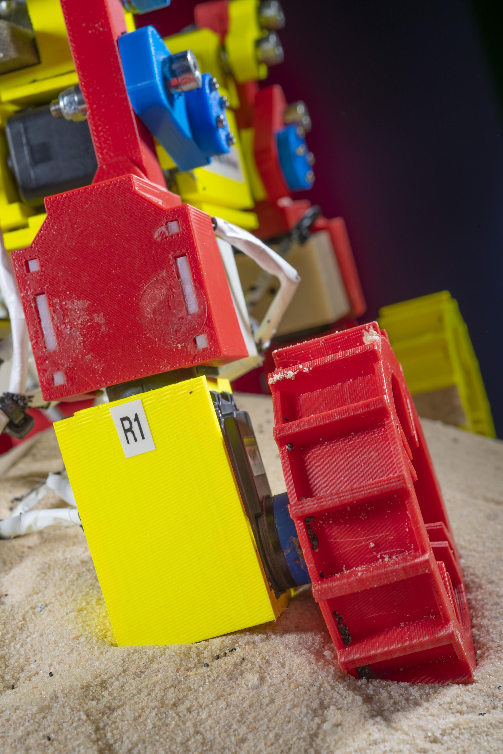 This close-up image shows one of the appendages of the Mini Rover. The leg can be raised and lowered and the wheel moved from side to side to move through loose granular surfaces. (Credit: Christopher Moore, Georgia Tech)