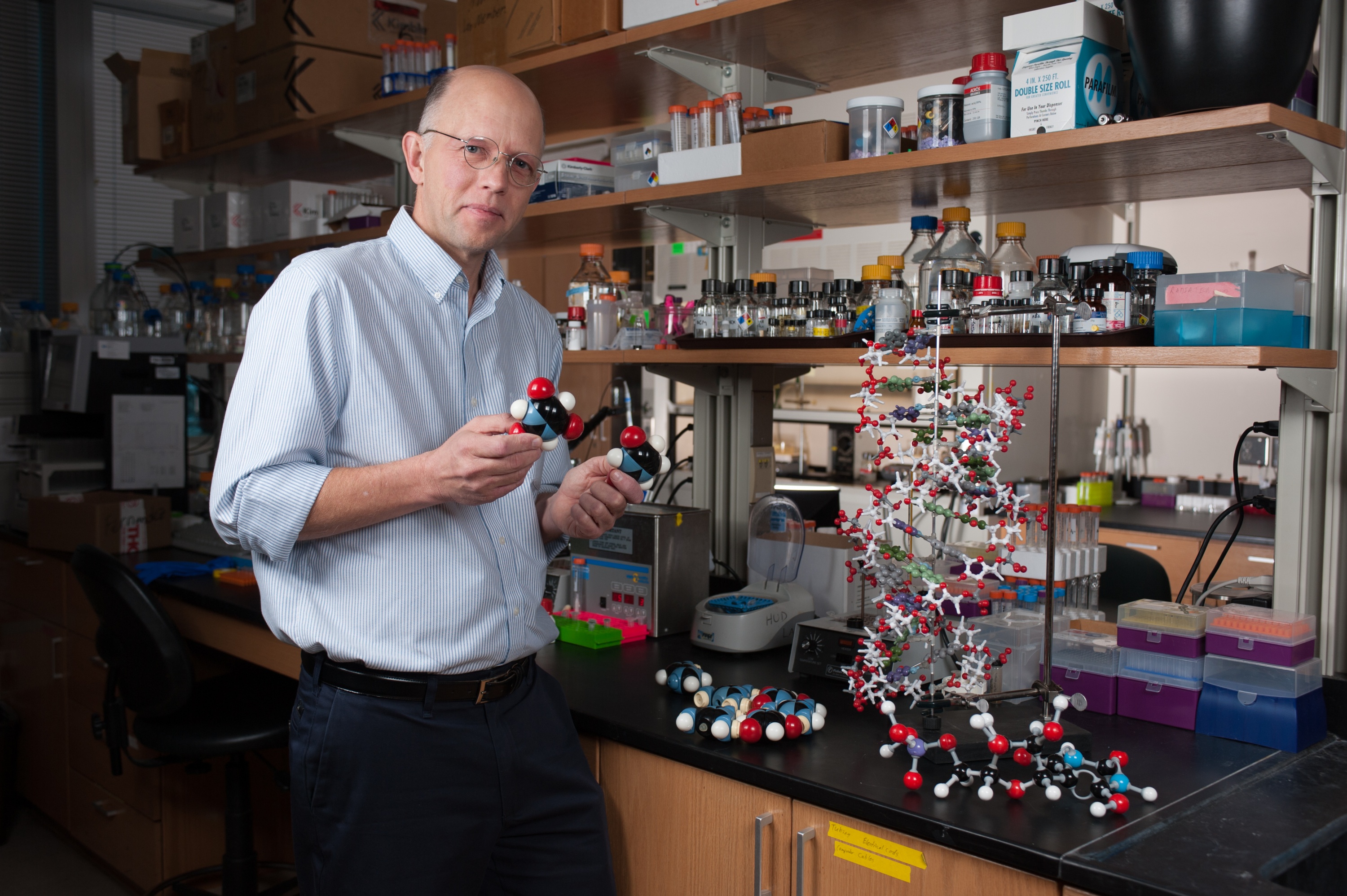 Nicholas Hud researches the possible origins of life chemicals on early Earth, when many of them may have formed in puddles. He has produced good candidates for precursors of RNA in easy reactions and in plentiful quantities using triaminopyrimidine, Cyanuric acid, barbituric acid, and melamine. Credit: Georgia Tech / Fitrah Hamid