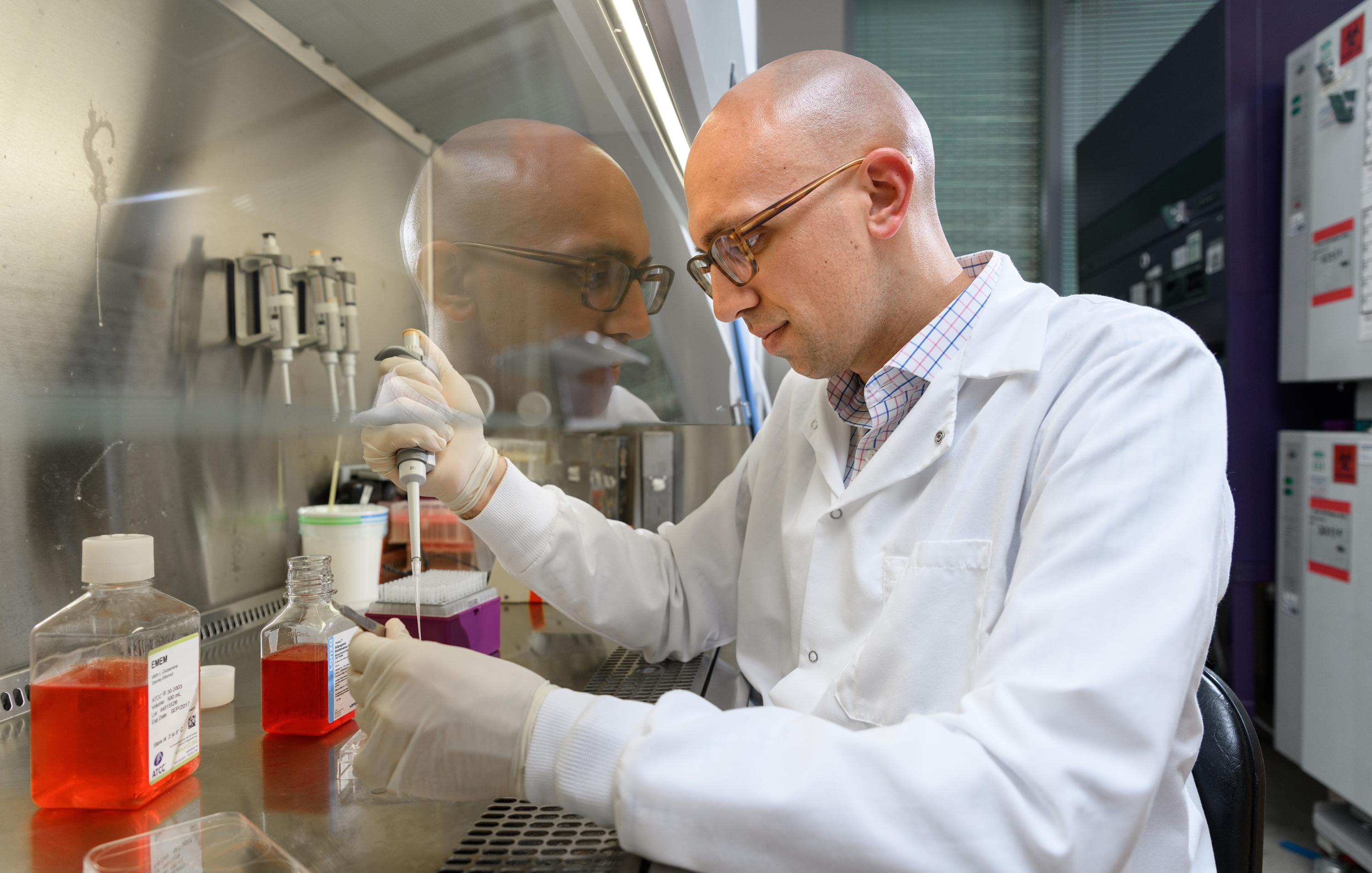 Researcher Christopher Johnson prepares hydrogel samples containing both an enzyme that battles bacterial infections and a protein that encourages bone growth. (Photo: Rob Felt, Georgia Tech)