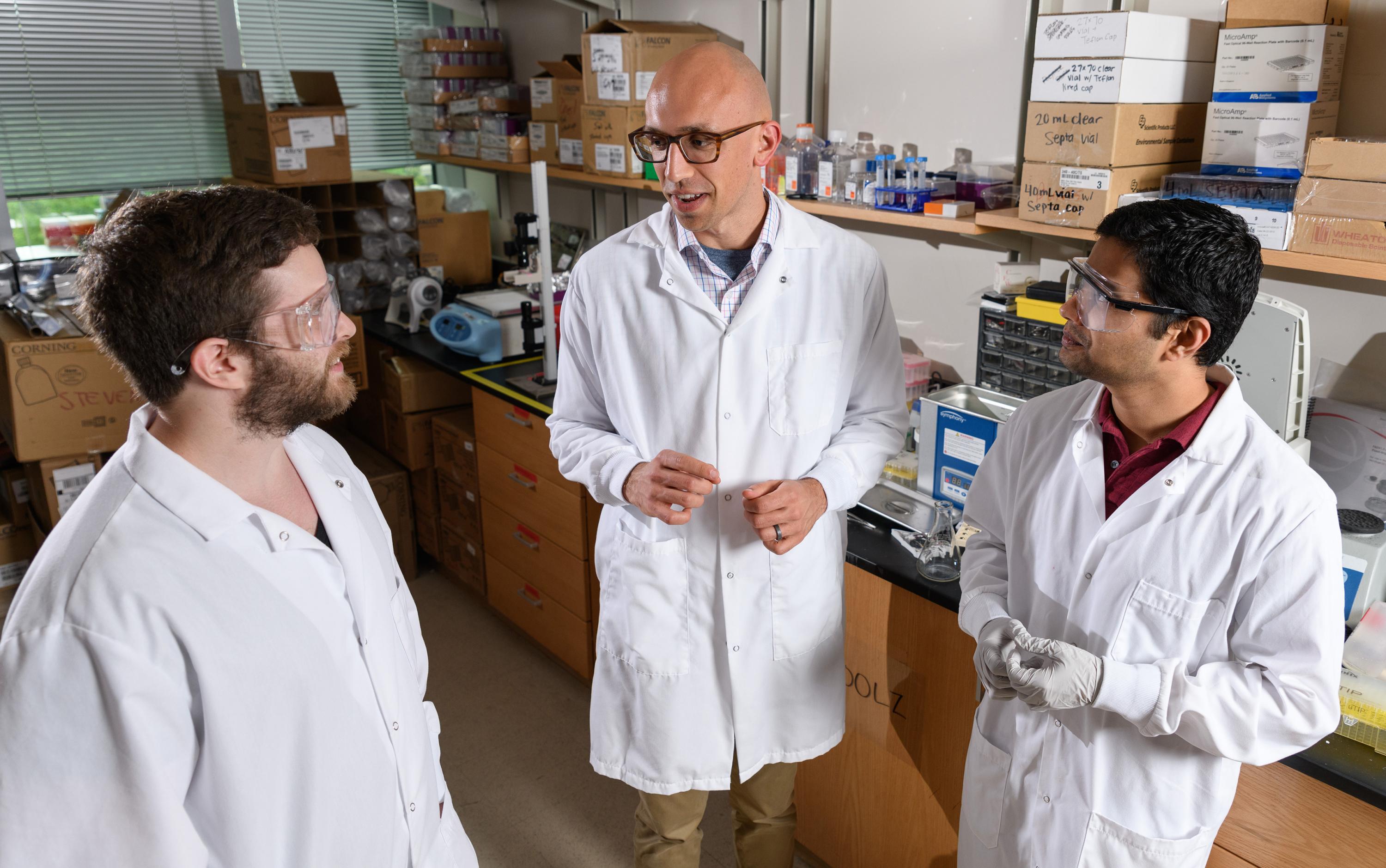 Researchers Jeremy Caplin, Christopher Johnson and Pranav Kalelkar discuss their work on a new hydrogel-based treatment for bone infections. (Photo: Rob Felt, Georgia Tech)