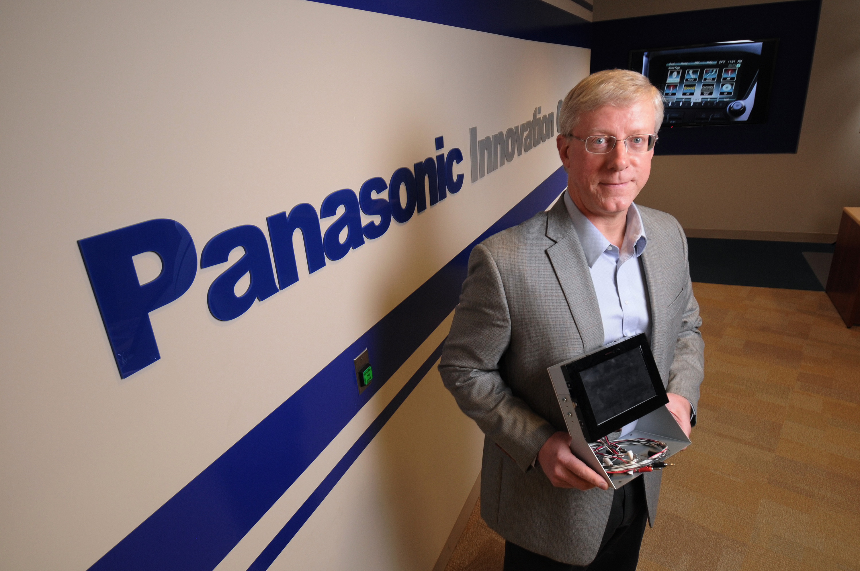 John Avery, group manager for the Panasonic Innovation Center at Tech Square, displays a prototype head unit that is being used to develop new automotive stereo-system features. (Georgia Tech Photo: Gary Meek)