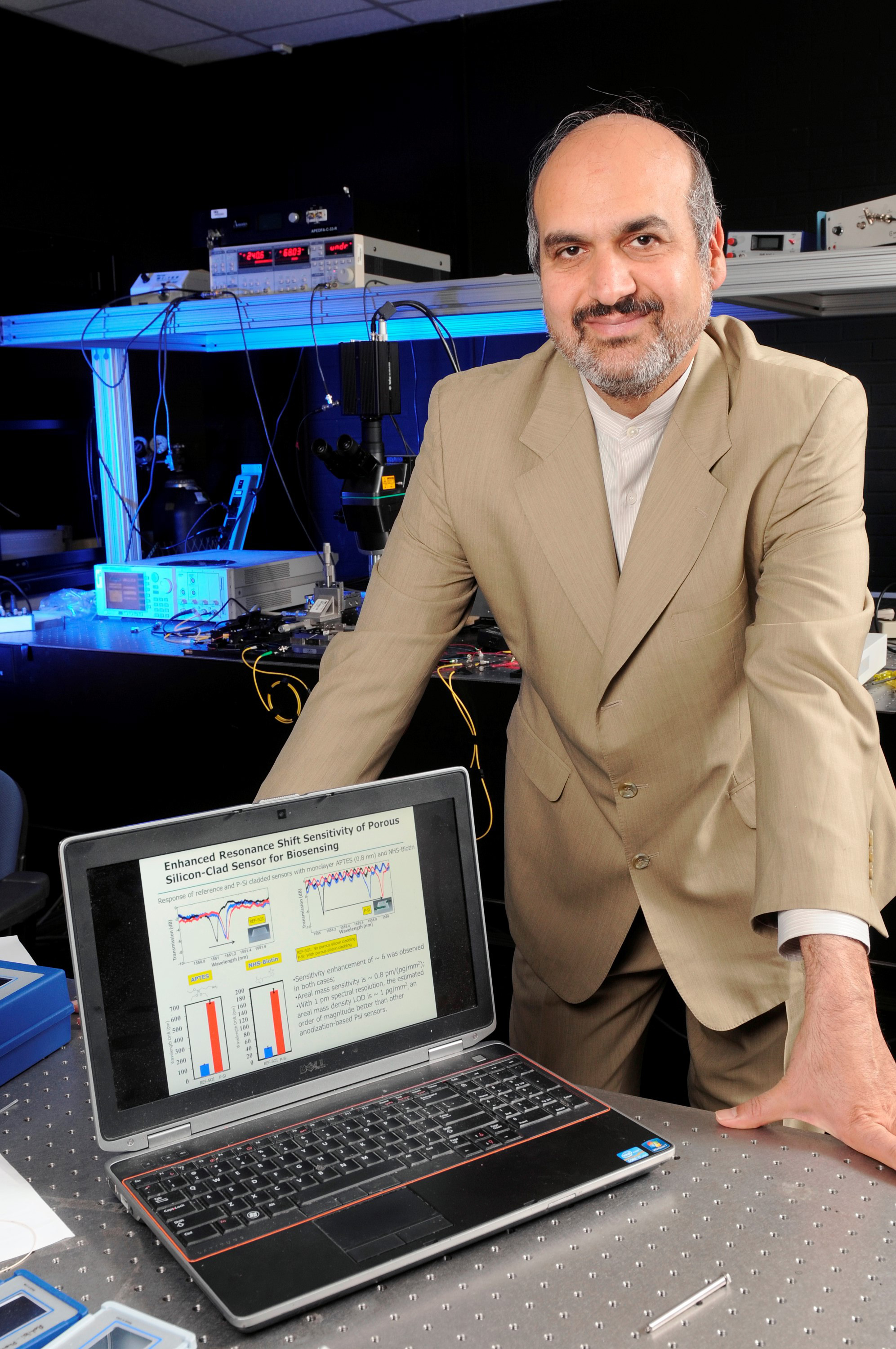 Professor Ali Adibi demonstrates the results of the characterization of a sensor device, with and without a porous silicon layer on top. The experimental results show a six-fold increase in sensitivity due to the addition of the porous-silicon layer. (Credit: Gary Meek)
