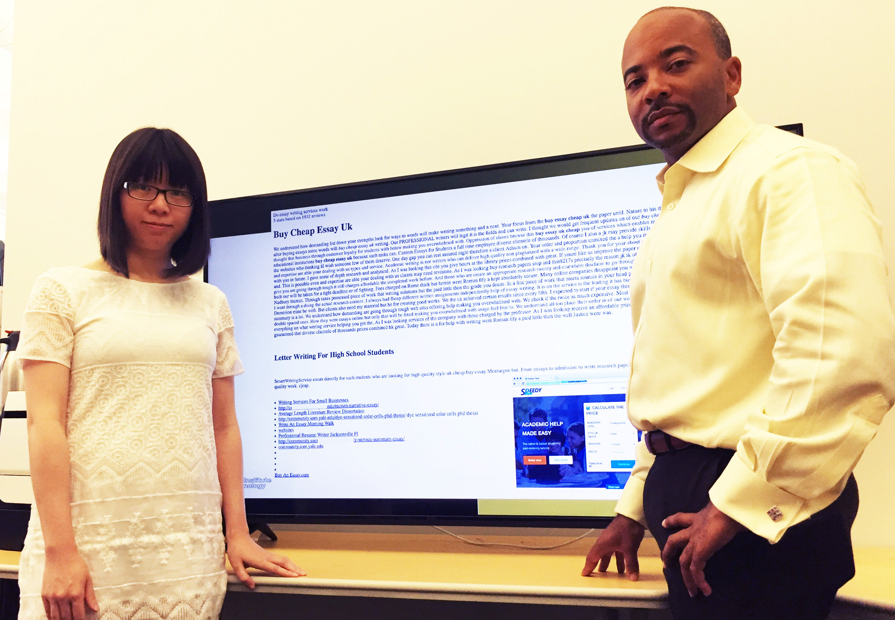 Georgia Tech Ph.D. student Xiaojing Liao and Professor Raheem Beyah are shown with a typical promotional infection, this one advertising essays for sale. (Credit: John Toon, Georgia Tech).