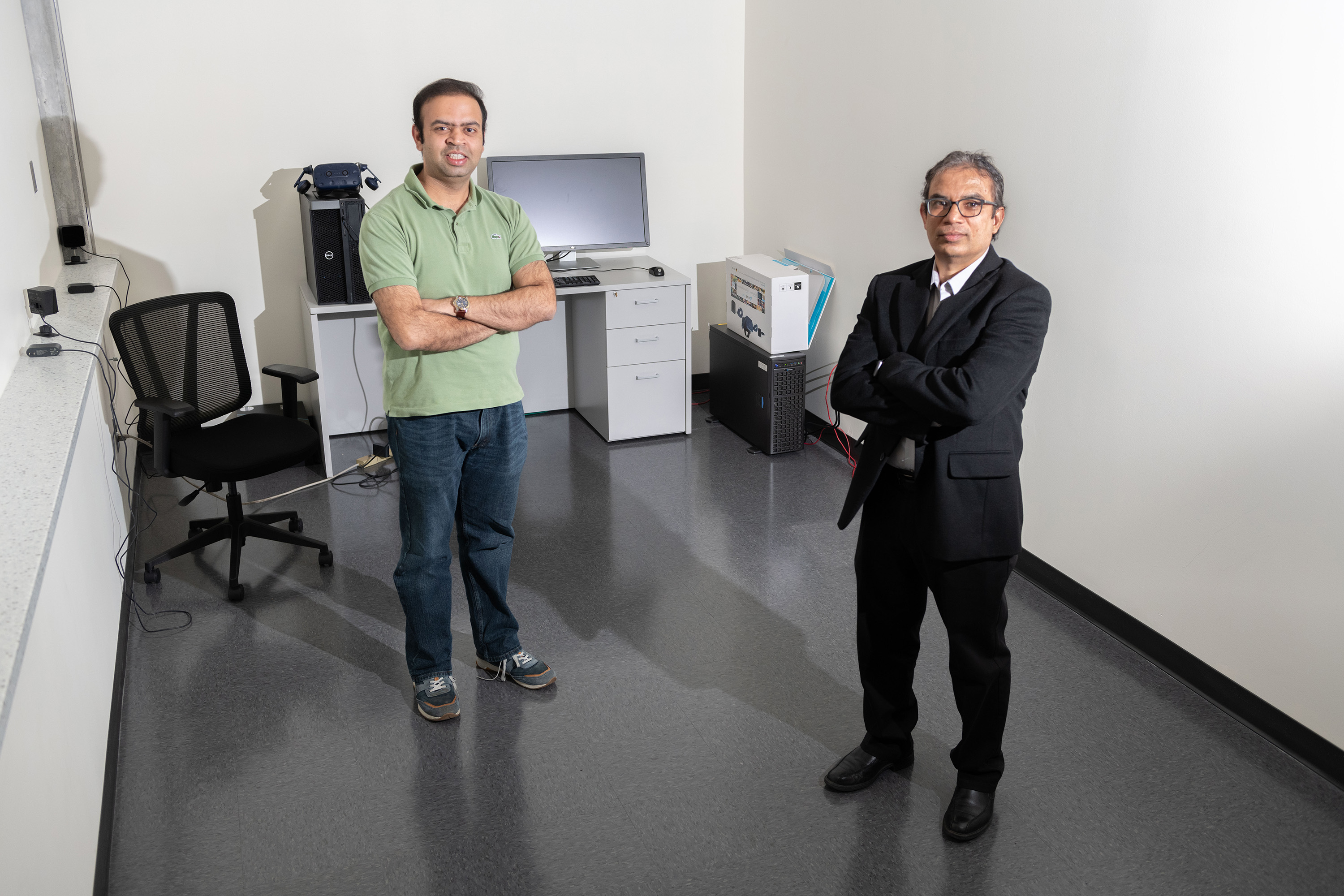 Anand Chandrasekaran, a postdoctoral researcher, and Rampi Ramprasad, a professor in the School of Materials Science and Engineering, stand in a room with a high-powered computer dedicated to machine learning. (Credit: Allison Carter)