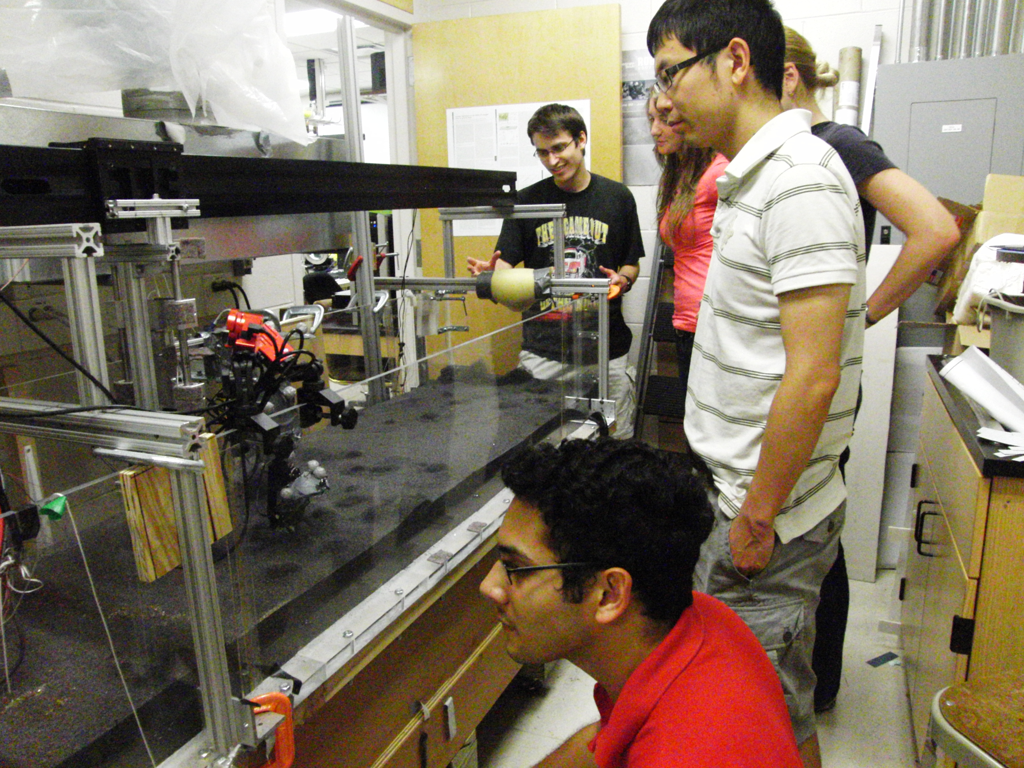 Mark Kingsbury (back) works with fellow researchers on the Robosaur in the Complex Rheology and Biomechanics Lab.