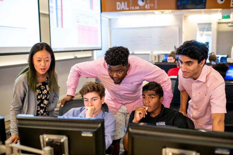 High School students in Georgia Tech's Wall Street on West Peachtree program anxiously watch stock returns as they compete to see who built the best portfolio of investments. 
