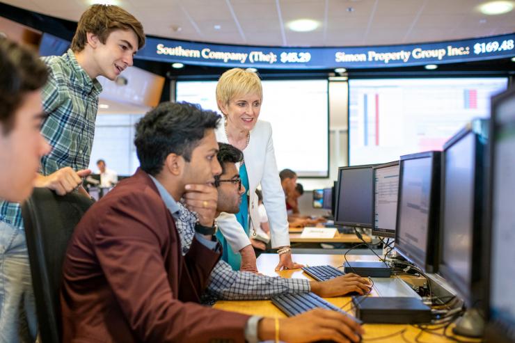 Scheller College of Business lecturer and finance expert Jacqueline Garner advises high school students on stock options at Georgia Tech's Wall Street on West Peachtree camp.