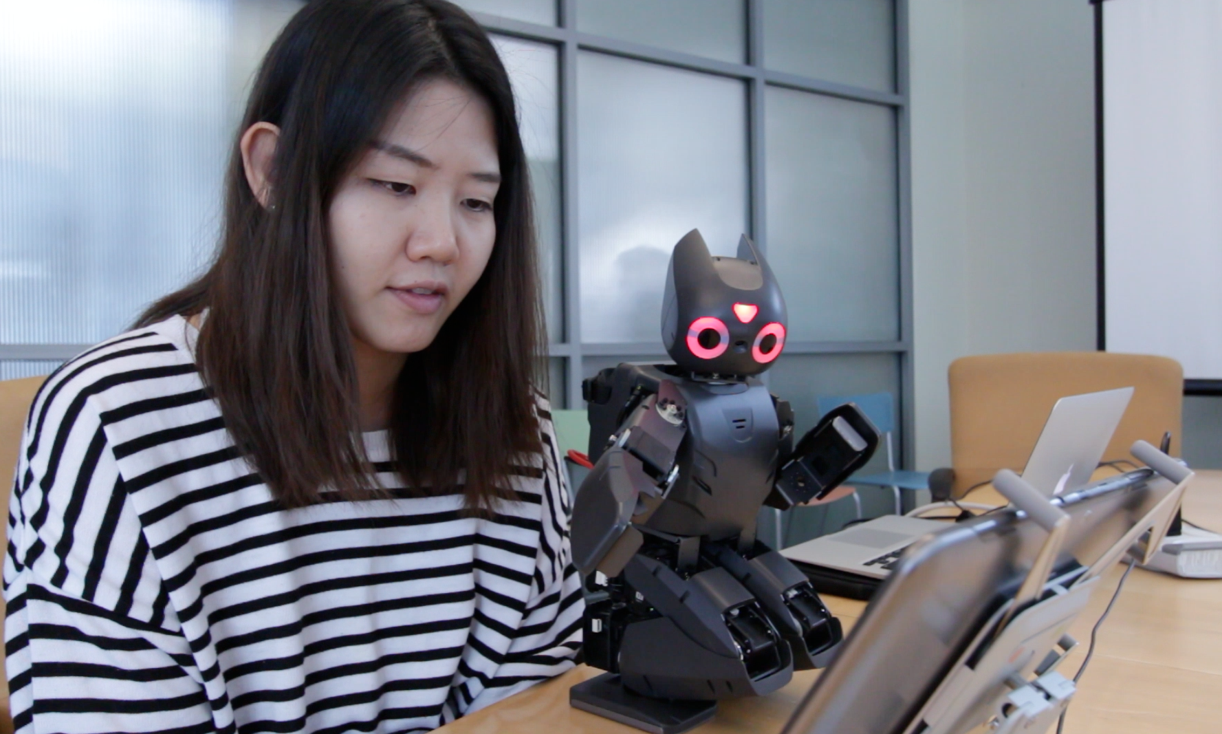 Hae Won Park, a postdoctoral fellow in the School of Electrical and Computing Engineering, teaches a robot how to play Angry Birds