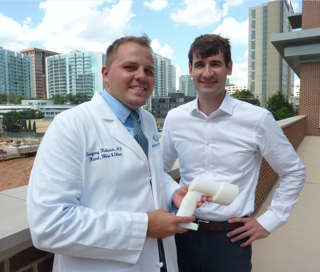 Dr. Greg Kolovich, an orthopedic hand and micro-surgeon (left), stands with business partner Evan Ruff. Kolovich is the founder of Micro C, a Savannah-based company that developed an all-in-one, hand-held X-ray and digital camera for surgeons and physicians treating disorders of the extremities. Ruff is CEO and a third partner,  Kirby Sisk, is chief operating officer. Kolovich, Ruff, and Sisk are all graduates of Georgia Tech. (Photo credit: Péralte C. Paul)
