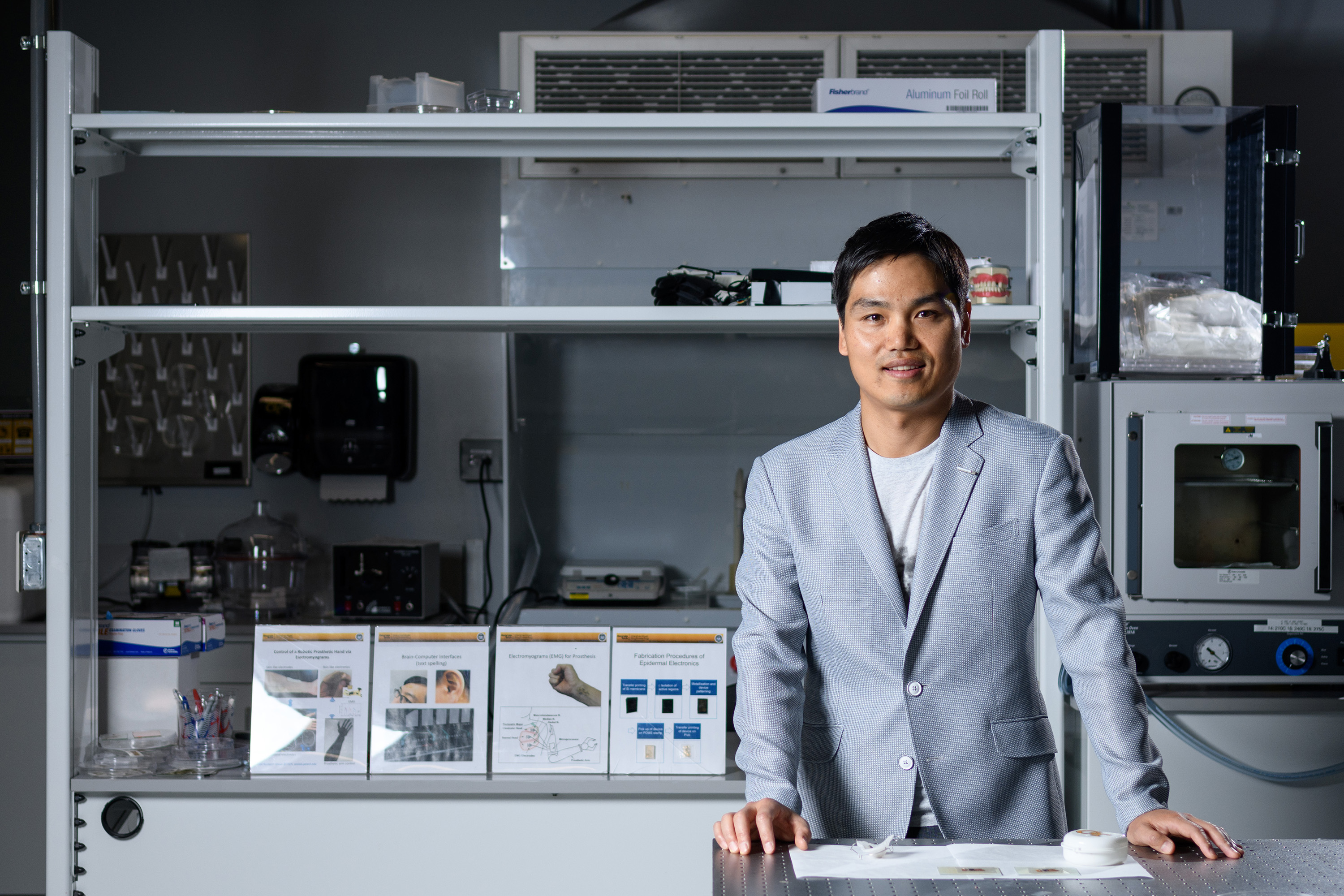 Woon-Hong Yeo, an assistant professor in the Woodruff School of Mechanical Engineering and Institute for Electronics and Nanotechnology at the Georgia Institute of Technology, is shown with the sodium sensor in his laboratory. (Credit: Rob Felt, Georgia Tech).