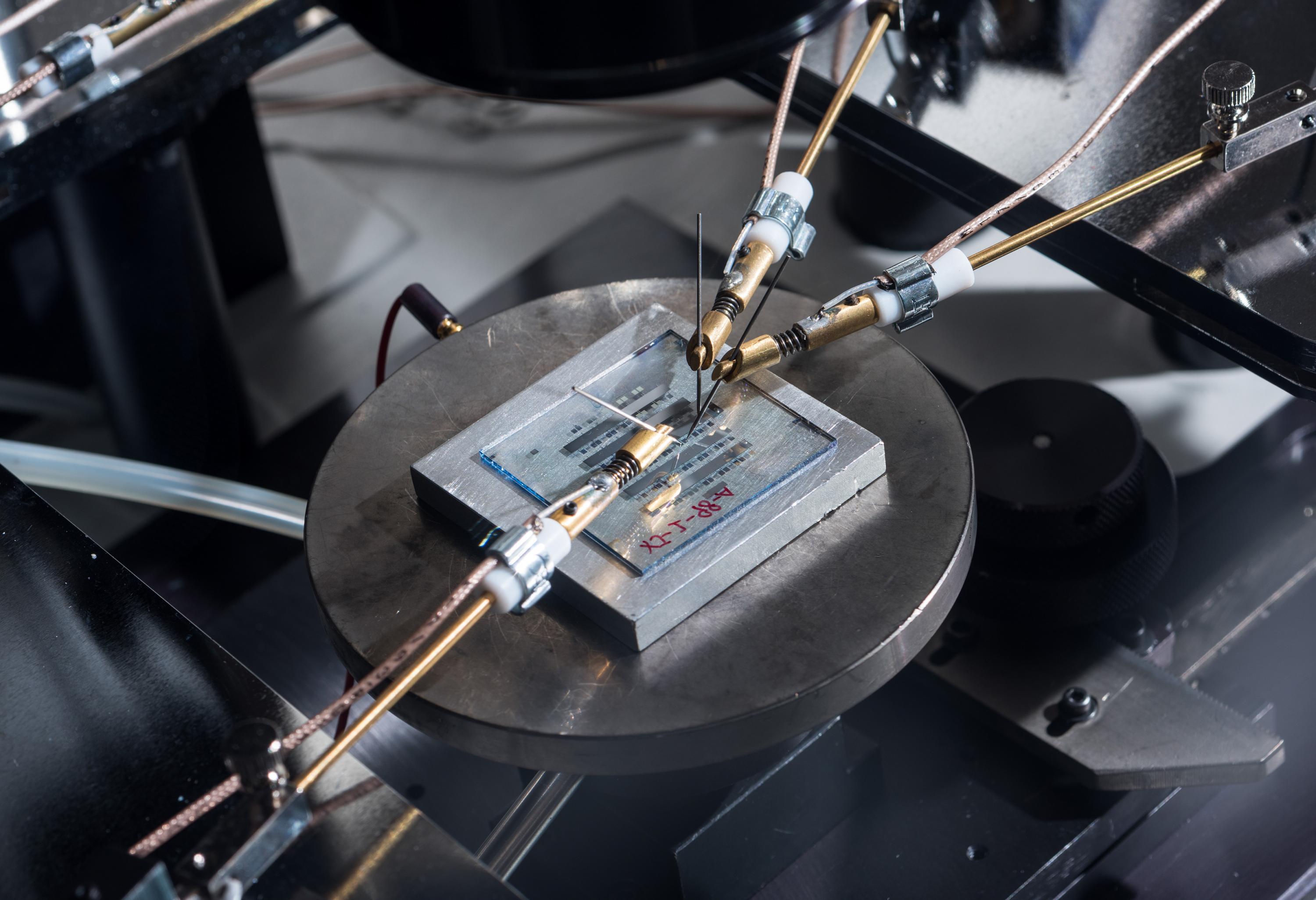 Image shows organic-thin film transistors with a nanostructured gate dielectric under continuous testing on a probe station. (Credit: Rob Felt, Georgia Tech)