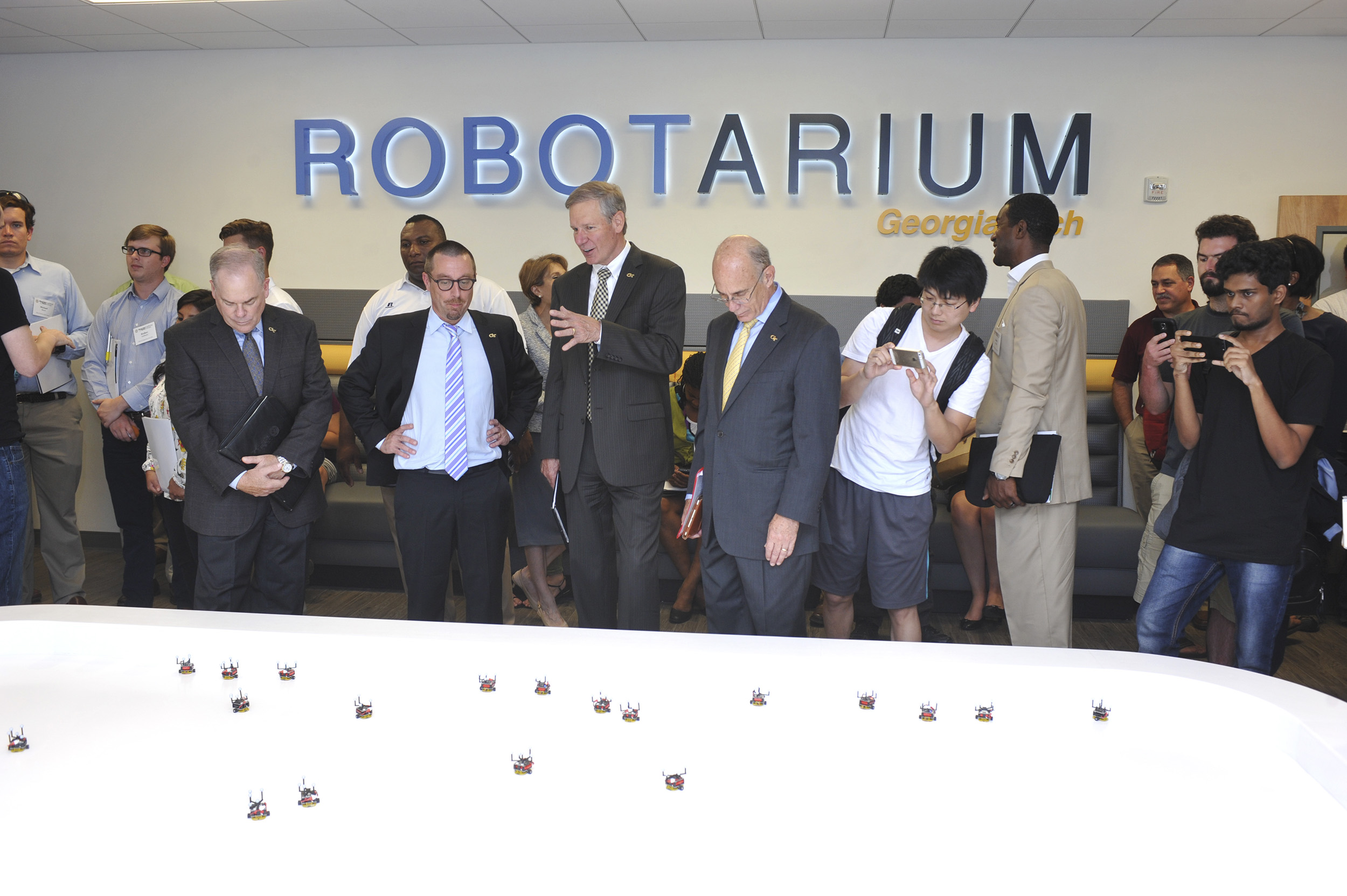 Left to right: Steve Cross, Magnus Egerstedt, G.P. "Bud" Peterson and Rafael Bras watch a robot demo at the Robotarium.
