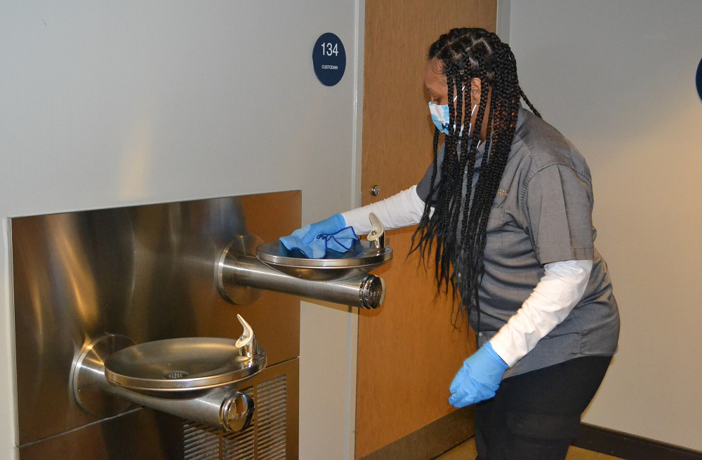 woman cleaning water fountain area