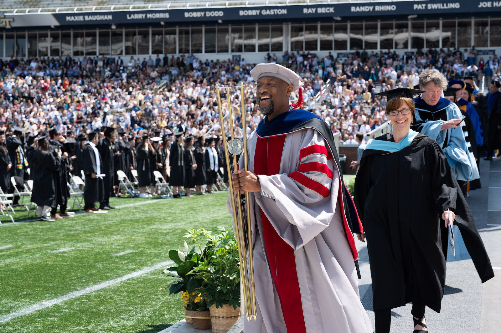 Dean Charles Isbell carrying the mace during Bachelor's ceremony. 