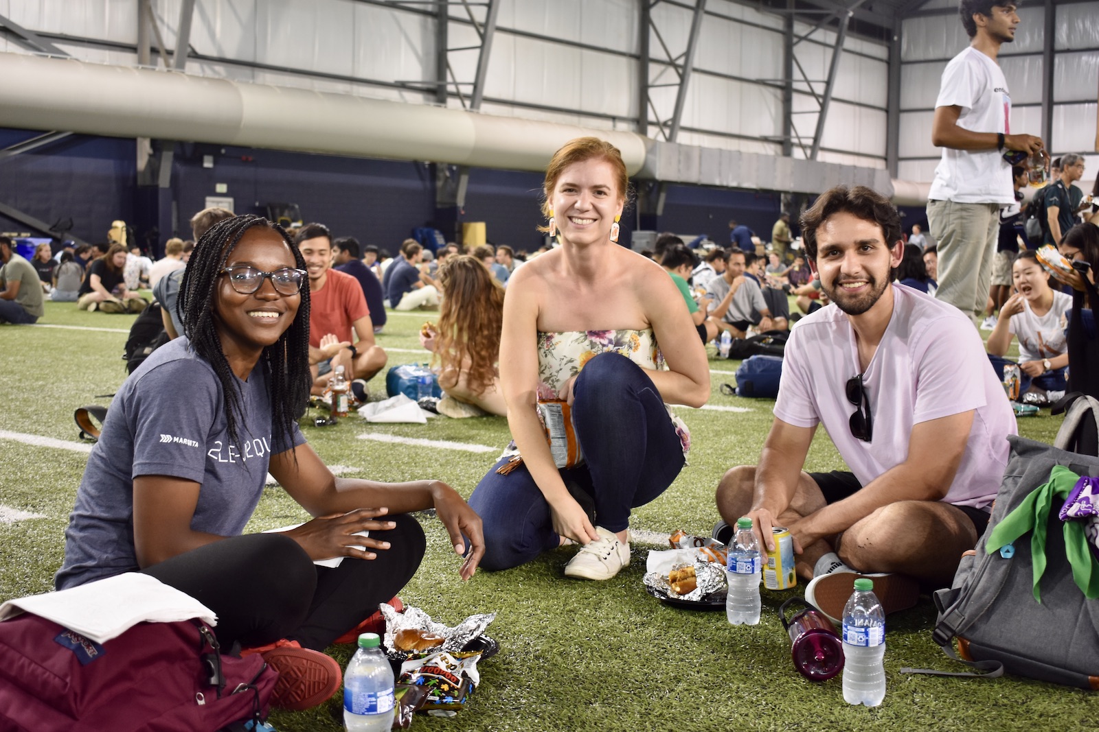 Students enjoying the Gaduate Student Welcome picnic at teh Mary and John Brock football practice facility.