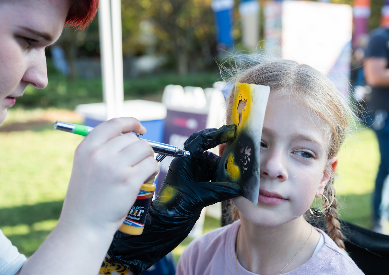 Little Yellow Jacket gets "GT" spray painted on her face.