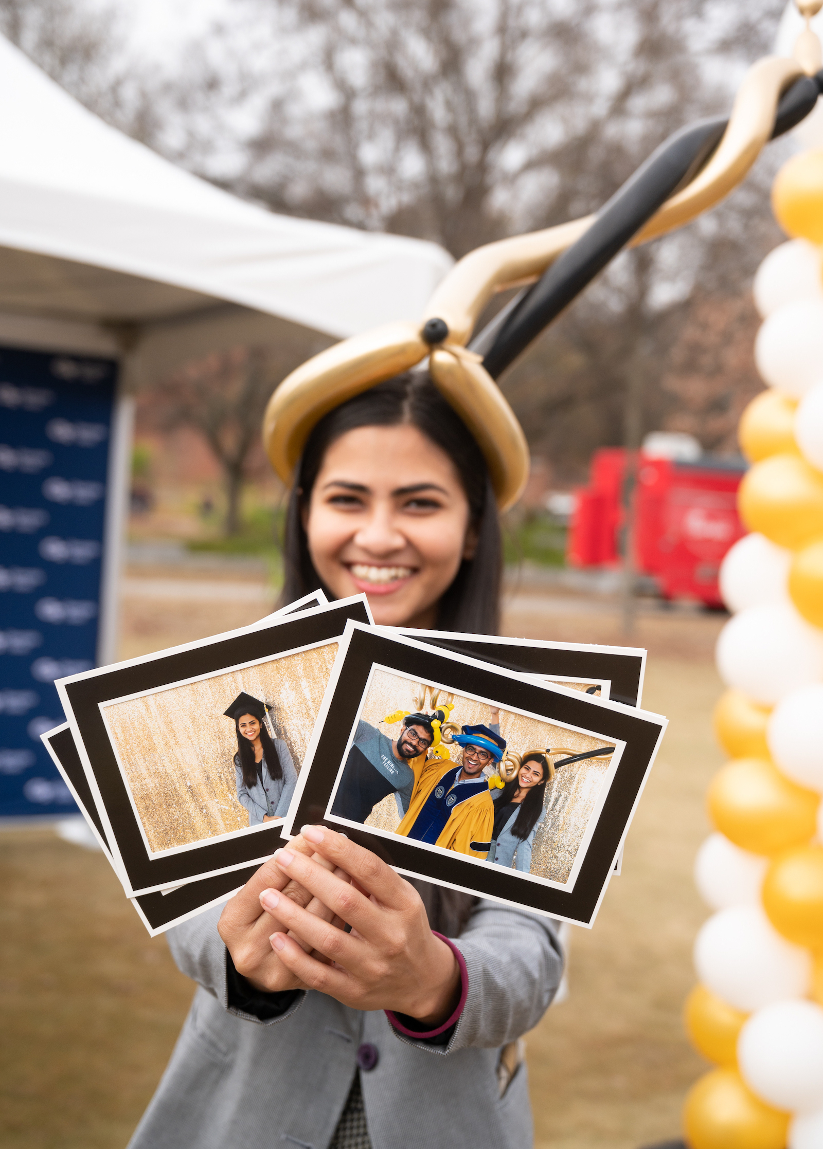 graduate holding photos taken in a photo booth