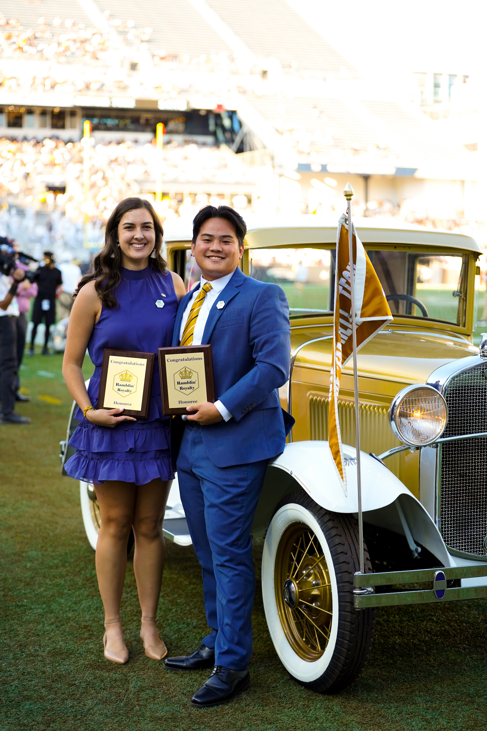 Ramblin' Royalty at Homecoming, standing next to the Ramblin' Wreck