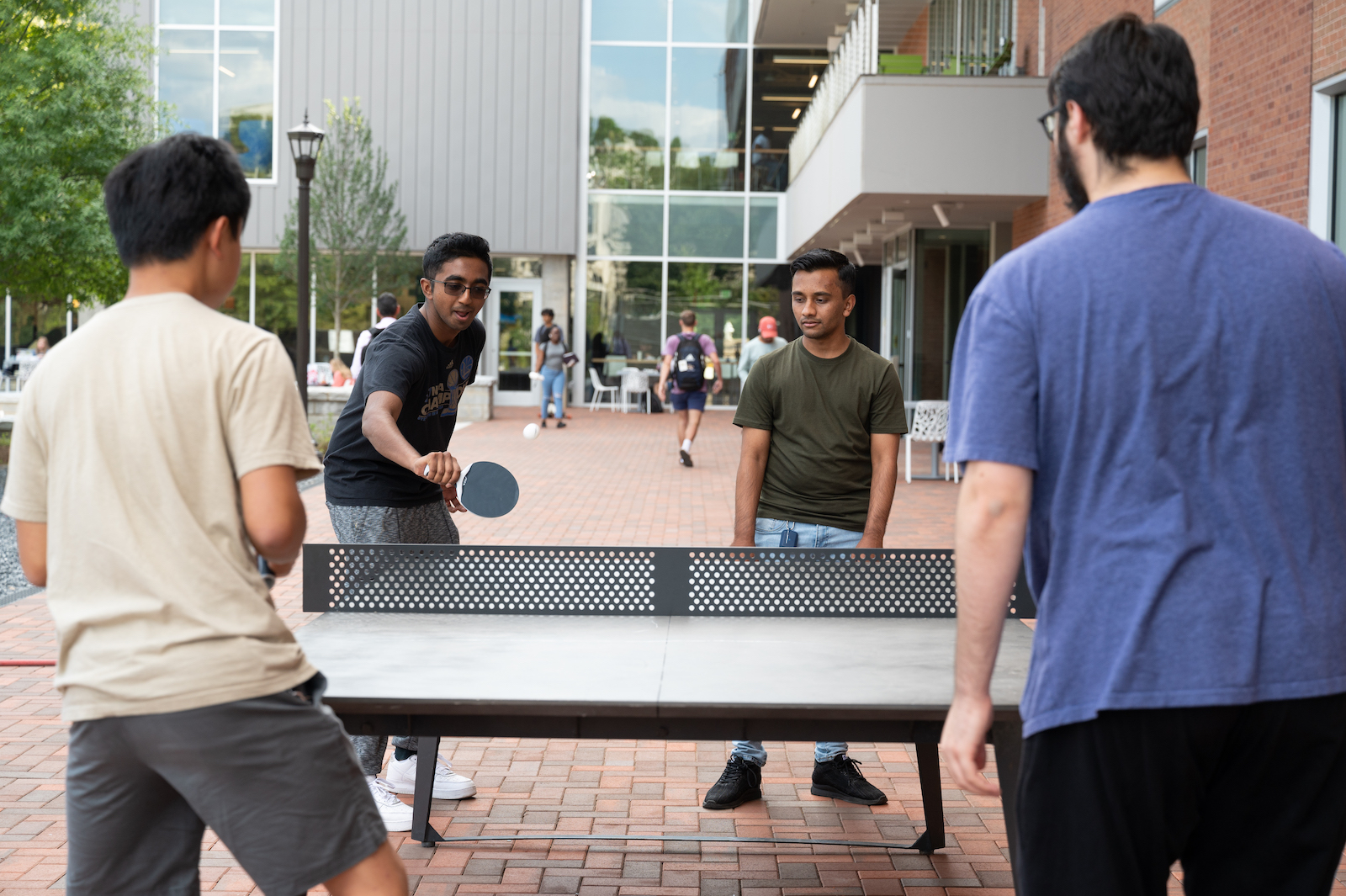 Students playing pin pong outside the student center.