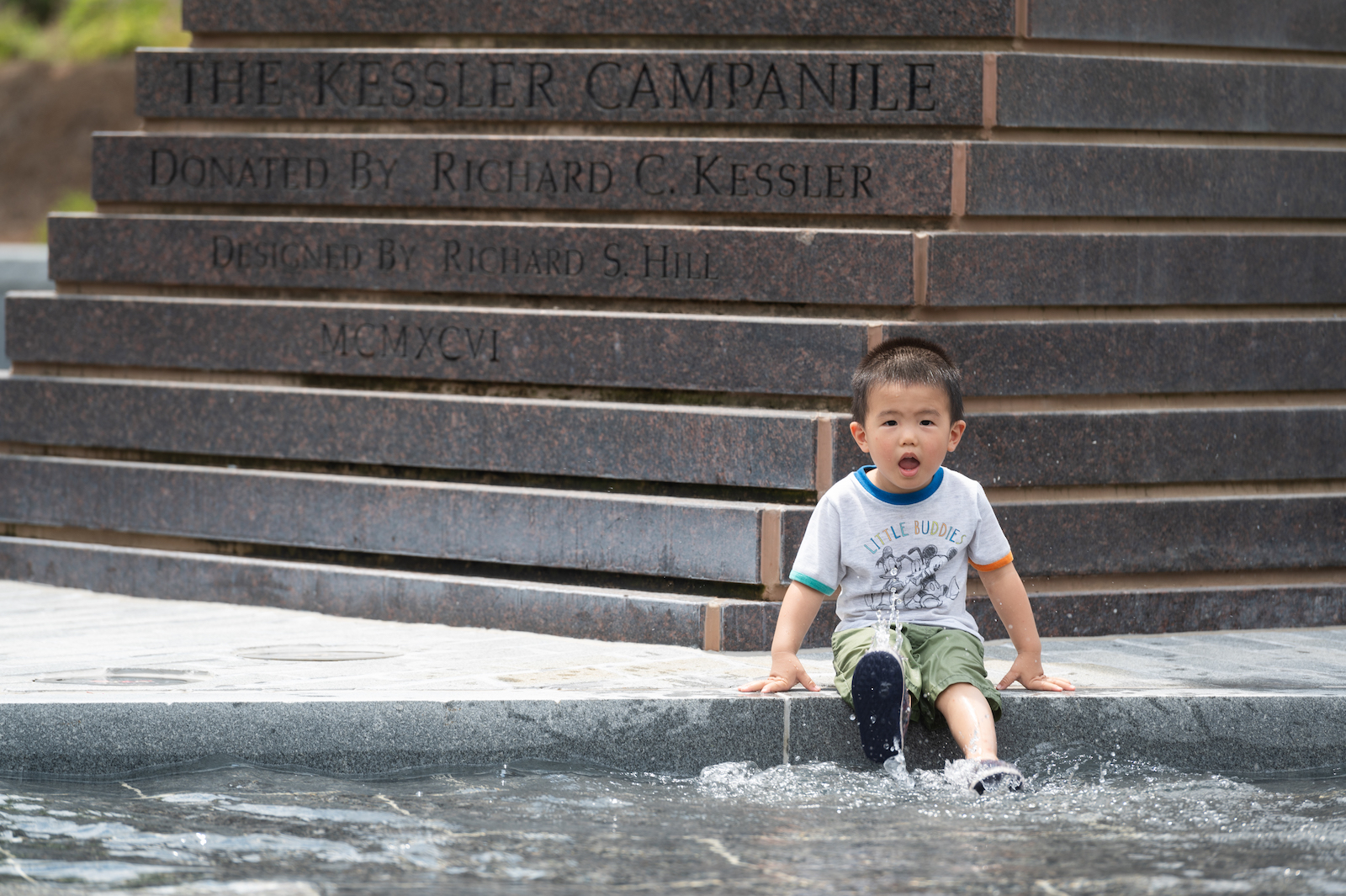 little boy in fountain at Kessler Campanile