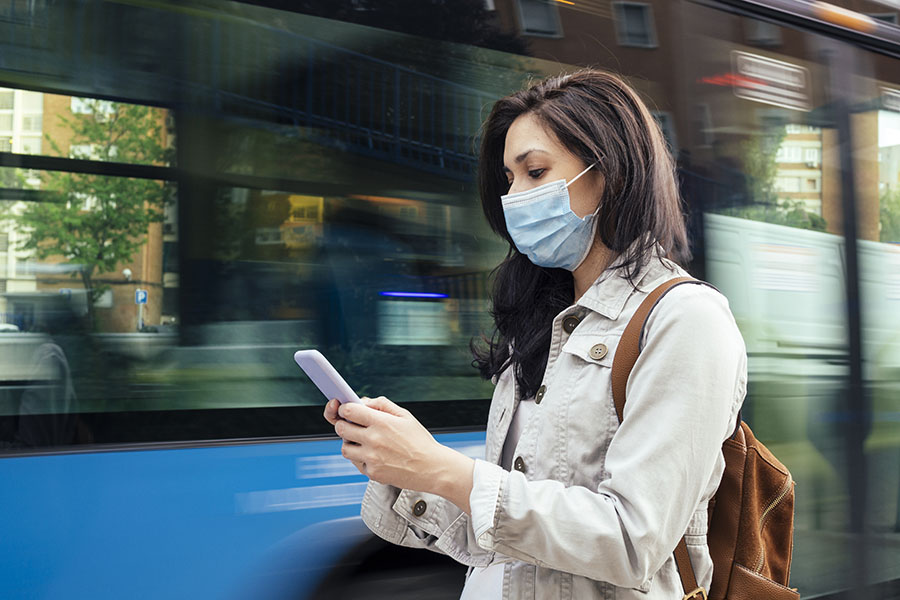 Woman using her phone during a commute