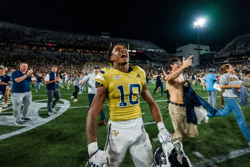 Tech fans rush the field after Tech defeats UNC at homecoming. 