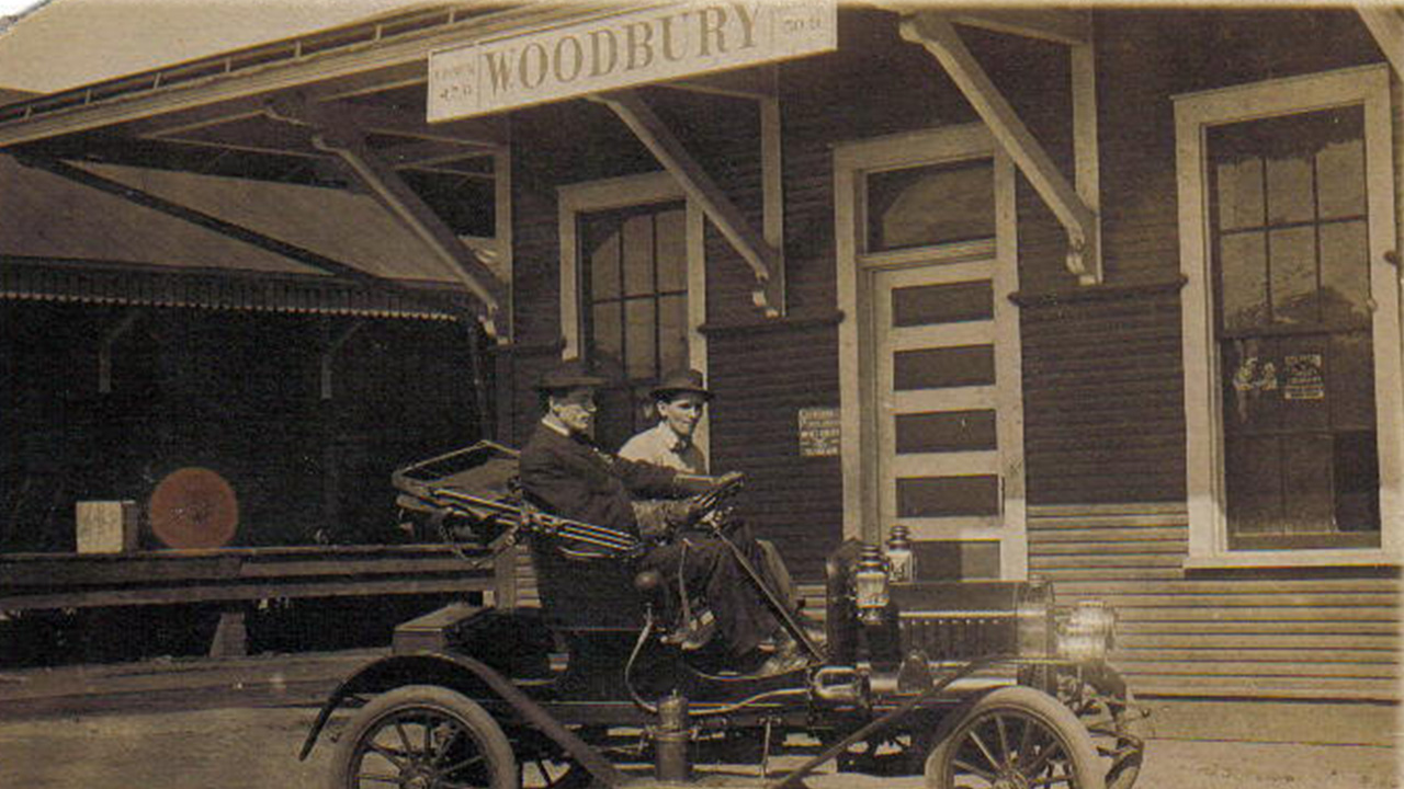 Two men sit in a car on Main Street in Woodbury in 1931.