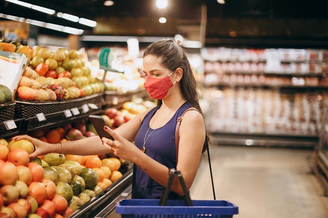 a woman shopping for produce in a grocery store