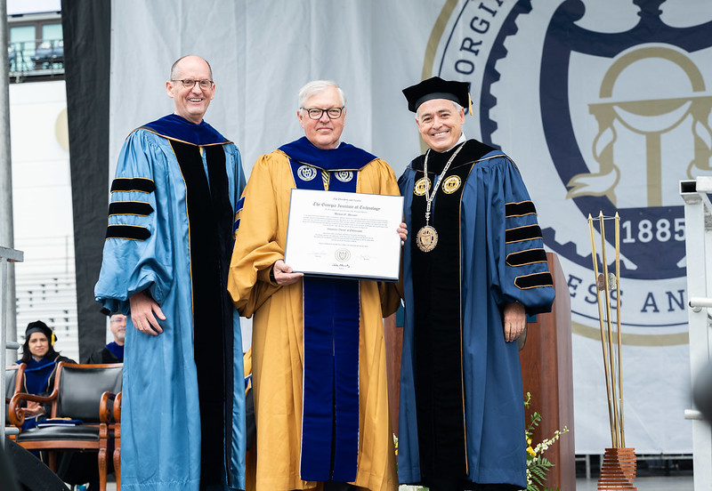 Mike Messner receives an honorary doctorate from Georgia Tech, flanked by Provost Steve McLaughlin and President Ángel Cabrera.