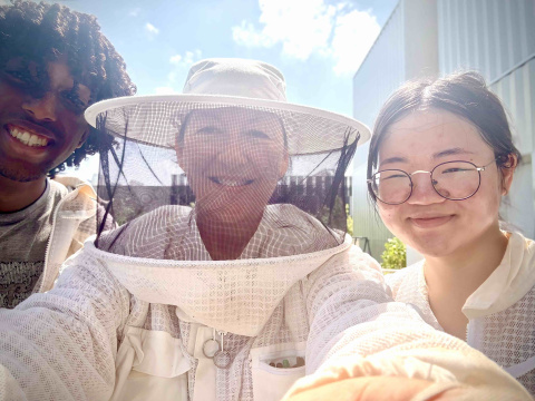 Beekeeper in Residence Deb DeWitt (center) educates undergraduate students Omar Malik (left) and Alyssa Zhang (right). 