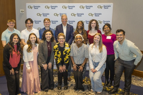 Students and donors posing for a photo, smiling