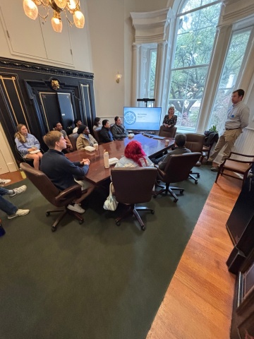 A group sitting around a big table in a conference room.