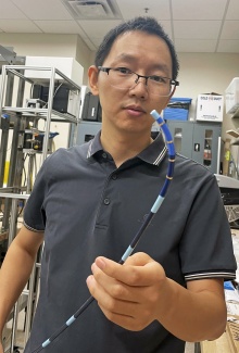 Yue Chen with robotic device