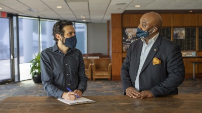 Staff members engage in conversation in the Wardlaw Center.