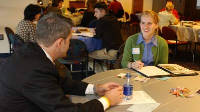 A student talks with a recruiter at a career event. 