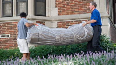 President G.P. "Bud" Peterson (right) helps with move-in in 2012