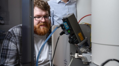 Matthew Boebinger, a graduate student at Georgia Tech, and Matthew McDowell, an assistant professor in the George W. Woodruff School of Mechanical Engineering and the School of Materials Science and Engineering, used an electron microscope to observe chemical reactions. (Credit: Rob Felt)