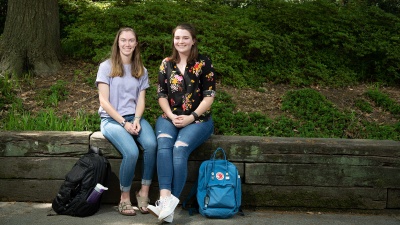 Chloe Thomas and Kayleigh Haskin outside the Nelson-Shell Apartments on West Campus. Photo by Allison Carter