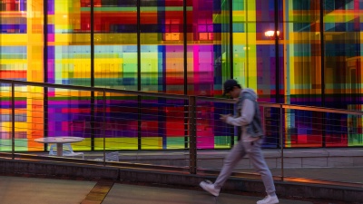 Student Walking by the Georgia Tech Library