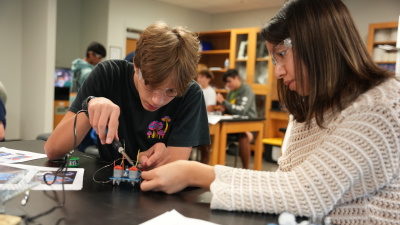 Two young leaners in a robotic lab.