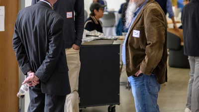 Three people talking to each other in a conference room