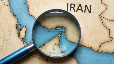 Image of a map of Iran, with a magnifying glass over the Strait of Hormuz