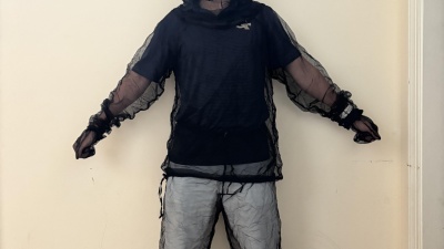 image of Chris Zuo in a mesh mosquito suit