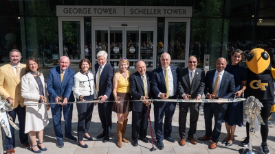 This image shows Georgia Tech and University System of Georgia leaders along with long time Georgia Tech supporters cutting the ribbon to officially open the new George and Scheller Towers at Georgia Tech