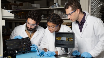 Ramy Ghanim, Joy Jackson, and Alex Abramson test a tiny implantable device in the lab.
